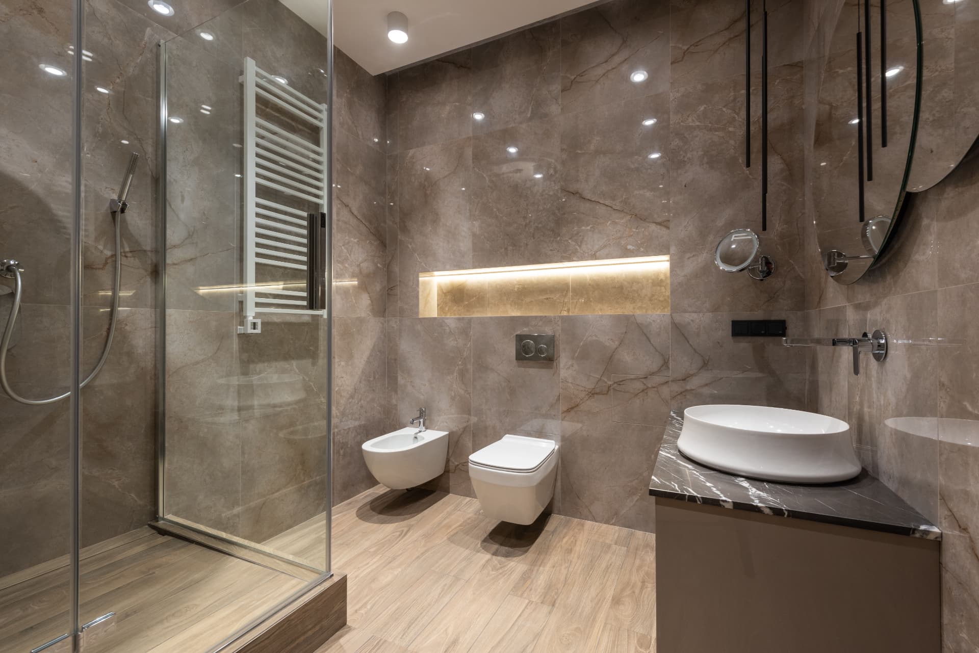 Sparkling marble bathroom with glass shower after a deep clean